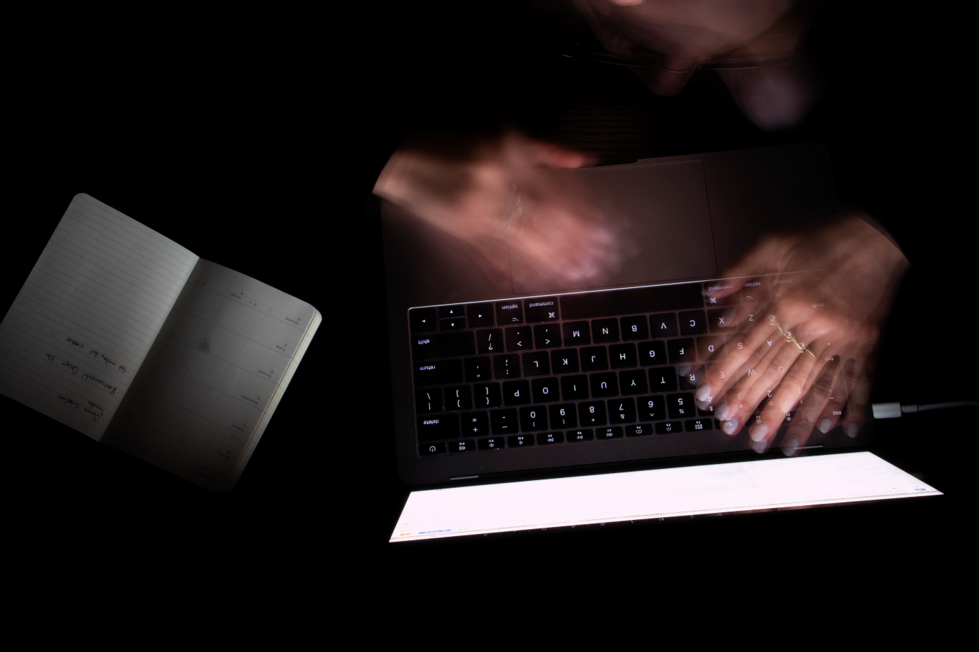 photo of blurred hands on a computer 